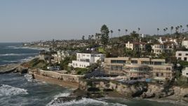 4K aerial stock footage tilt from the ocean to reveal and flyby oceanfront mansions, La Jolla, California Aerial Stock Footage | DCA08_241E