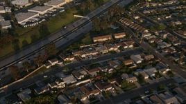 4K aerial stock footage fly away from freeway and tract homes, Clairemont Mesa East, California, Sunset Aerial Stock Footage | DCA08_270