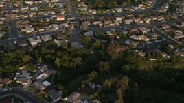 4K aerial stock footage of a reverse view of suburban tract homes in Clairemont, California, Sunset Aerial Stock Footage | DCA08_273