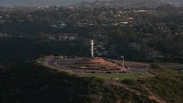 4K aerial stock footage orbit the Soledad Cross religious monument in La Jolla, California, Sunset Aerial Stock Footage | DCA08_278E