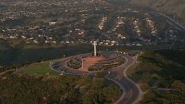 4K aerial stock footage of flying by the Soledad Cross religious monument, La Jolla, California, Sunset Aerial Stock Footage | DCA08_280
