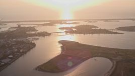 4K aerial stock footage of flying by an island in a bay, reveal SeaWorld San Diego theme park, California, Sunset Aerial Stock Footage | DCA08_288