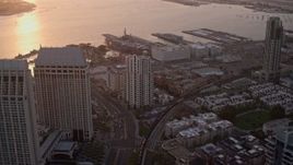 4K aerial stock footage of flying over downtown skyscrapers to luxury hotel and marina in Downtown San Diego, California, Sunset Aerial Stock Footage | DCA08_303