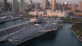 4K aerial stock footage orbit the aircraft carrier, USS Midway, in Downtown San Diego, California, Sunset Aerial Stock Footage | DCA08_306