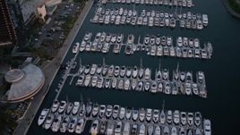 4K aerial stock footage of a reverse view of a marina in Downtown San Diego, California, Sunset Aerial Stock Footage | DCA08_313