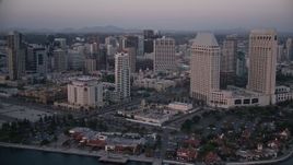 4K aerial stock footage pan across hotel to reveal seafood company in Downtown San Diego, California, Sunset Aerial Stock Footage | DCA08_320E