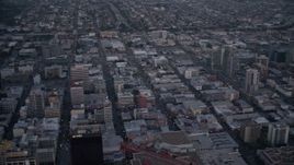 4K aerial stock footage pan across city skyscrapers, tilt to reveal streets, mall, and park in Downtown San Diego, California, Sunset Aerial Stock Footage | DCA08_324