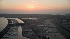 4K aerial stock footage of the setting sun over San Diego International Airport, California Aerial Stock Footage | DCA08_327