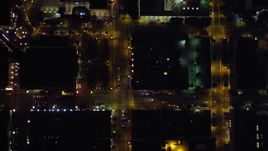 4K aerial stock footage of a bird's eye view of city streets, reveal city buildings in Downtown San Diego, California, Night Aerial Stock Footage | DCA08_361E