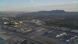5K aerial stock footage fly over runways at Burbank Airport and tilt to terminals at sunset, California Aerial Stock Footage | DCLA_002