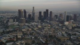 5K aerial stock footage tilt from Hollywood streets to reveal and approach Downtown Los Angeles skyline at sunset, California Aerial Stock Footage | DCLA_015