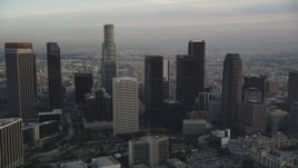 5K aerial stock footage tilt from city streets in Westlake to reveal and approach Downtown Los Angeles at sunset, California Aerial Stock Footage | DCLA_016
