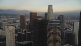 5K aerial stock footage tilt from busy street to reveal and approach Downtown Los Angeles, California skyscrapers at sunset Aerial Stock Footage | DCLA_026