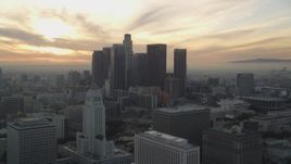 5K aerial stock footage reverse view of City Hall and Downtown Los Angeles skyline at sunset, California Aerial Stock Footage | DCLA_031