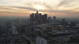 5K aerial stock footage of Downtown Los Angeles skyline with setting sun in the clouds, California Aerial Stock Footage | DCLA_034