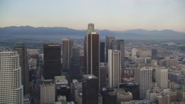 5K aerial stock footage tilt from busy streets, reveal and approach skyscrapers in Downtown Los Angeles at twilight, California Aerial Stock Footage | DCLA_042