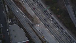5K aerial stock footage bird's eye view of tracking police helicopter over freeway at twilight in Downtown Los Angeles, California Aerial Stock Footage | DCLA_060