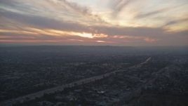 5K aerial stock footage of setting sun over Interstate 10 and suburbs in Mid-City Los Angeles, California Aerial Stock Footage | DCLA_067