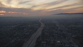 5K aerial stock footage of sunset in the clouds over Interstate 10 through Mid-City Los Angeles, California Aerial Stock Footage | DCLA_068