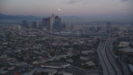 5K aerial stock footage of moon over Downtown Los Angeles skyline seen from I-10 at twilight, California Aerial Stock Footage | DCLA_069
