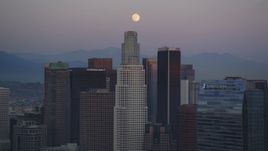 5K aerial stock footage tilt from rush hour traffic on I-110 to reveal moon over Downtown Los Angeles at twilight, California Aerial Stock Footage | DCLA_071