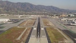 5K aerial stock footage tilt to reveal and approach runway at Burbank Airport, California Aerial Stock Footage | DCLA_103