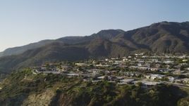 5K aerial stock footage tilt from Highway 1 to reveal neighborhood  on cliff in Malibu, California Aerial Stock Footage | DCLA_138