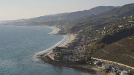 5K aerial stock footage tilt from ocean to reveal the coastal community of Malibu, California Aerial Stock Footage | DCLA_145