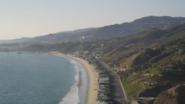 5K aerial stock footage pan from coastal foothills to beachfront homes in Malibu, California Aerial Stock Footage | DCLA_146