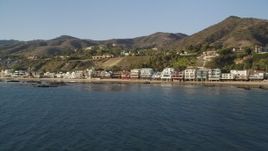 5K aerial stock footage fly low by beachfront homes in Malibu, California Aerial Stock Footage | DCLA_156