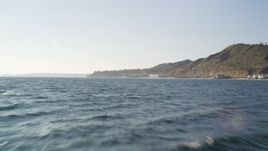 5K aerial stock footage tilt from the blue ocean to reveal and approach the coast of Malibu, California Aerial Stock Footage | DCLA_160