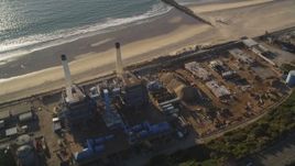 5K aerial stock footage fly over tanks to approach smoke stacks and beach in El Segundo, California Aerial Stock Footage | DCLA_196