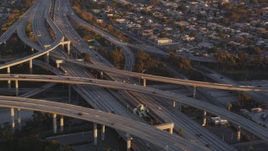 5K aerial stock footage tilt to reveal light traffic on the 110/105 interchange in Westmont at sunset, California Aerial Stock Footage | DCLA_204