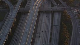 5K stock footage video of freeway interchange between I-110 and 105 in Westmont at sunset, California Aerial Stock Footage | DCLA_205