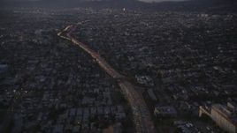 5K aerial stock footage of tilting up heavy traffic on Highway 101 by Echo Park at twilight, California Aerial Stock Footage | DCLA_268