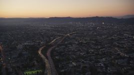 5K aerial stock footage tilt from Highway 101 by Echo Park to reveal Hollywood at twilight, California Aerial Stock Footage | DCLA_269