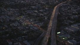 5K stock footage video tilt from bird's eye of Highway 101 to reveal Hollywood at twilight, California Aerial Stock Footage | DCLA_271