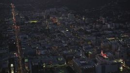 5K aerial stock footage approach Hollywood with bright lights on city streets at twilight, California Aerial Stock Footage | DCLA_275