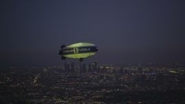 5K aerial stock footage of flying by an advertising blimp and reveal Downtown Los Angeles skyline at twilight, California Aerial Stock Footage | DCLA_279