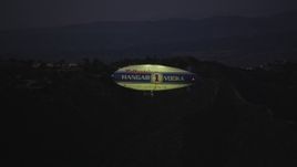 5K aerial stock footage of tracking a blimp flying by Hollywood Hills at twilight, California Aerial Stock Footage | DCLA_280