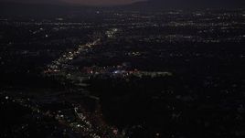 5K aerial stock footage tilt from Highway 101 traffic to reveal Universal City at night, California Aerial Stock Footage | DCLA_284