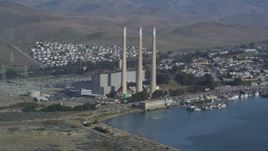 5K aerial stock footage Flying by Dynegy Morro Bay power plant, eclipsed by Morro Rock, Morro Bay, California Aerial Stock Footage | DCSF03_001