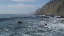 5K aerial stock footage Flying low over crashing ocean raves, rocks, by coastal cliffs, San Simeon, California Aerial Stock Footage | DCSF03_029
