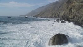 5K aerial stock footage Flying low over churning ocean at the base of coastal cliffs, San Simeon, California Aerial Stock Footage | DCSF03_032