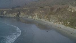 5K aerial stock footage Fly over deserted beach at the base of cliffs, Big Sur, California Aerial Stock Footage | DCSF03_040