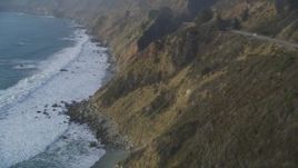 5K aerial stock footage Pan to reveal waves rolling toward cliffs, Big Sur, California Aerial Stock Footage | DCSF03_045