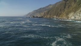 5K aerial stock footage Flying low over the Pacific Ocean, pan to coastal cliffs, Big Sur, California Aerial Stock Footage | DCSF03_050
