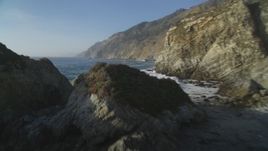 5K aerial stock footage Pan from coastal cliffs, reveal and fly over rock formations, Big Sur, California Aerial Stock Footage | DCSF03_051