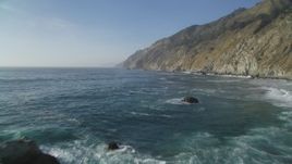 5K aerial stock footage Fly low over Pacific Ocean to approach coastal cliffs, Big Sur, California Aerial Stock Footage | DCSF03_052