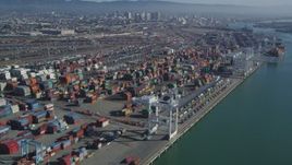 5K aerial stock footage Flying by cargo cranes, and stacks of shipping containers, Port of Oakland, Oakland, California Aerial Stock Footage | DCSF05_077